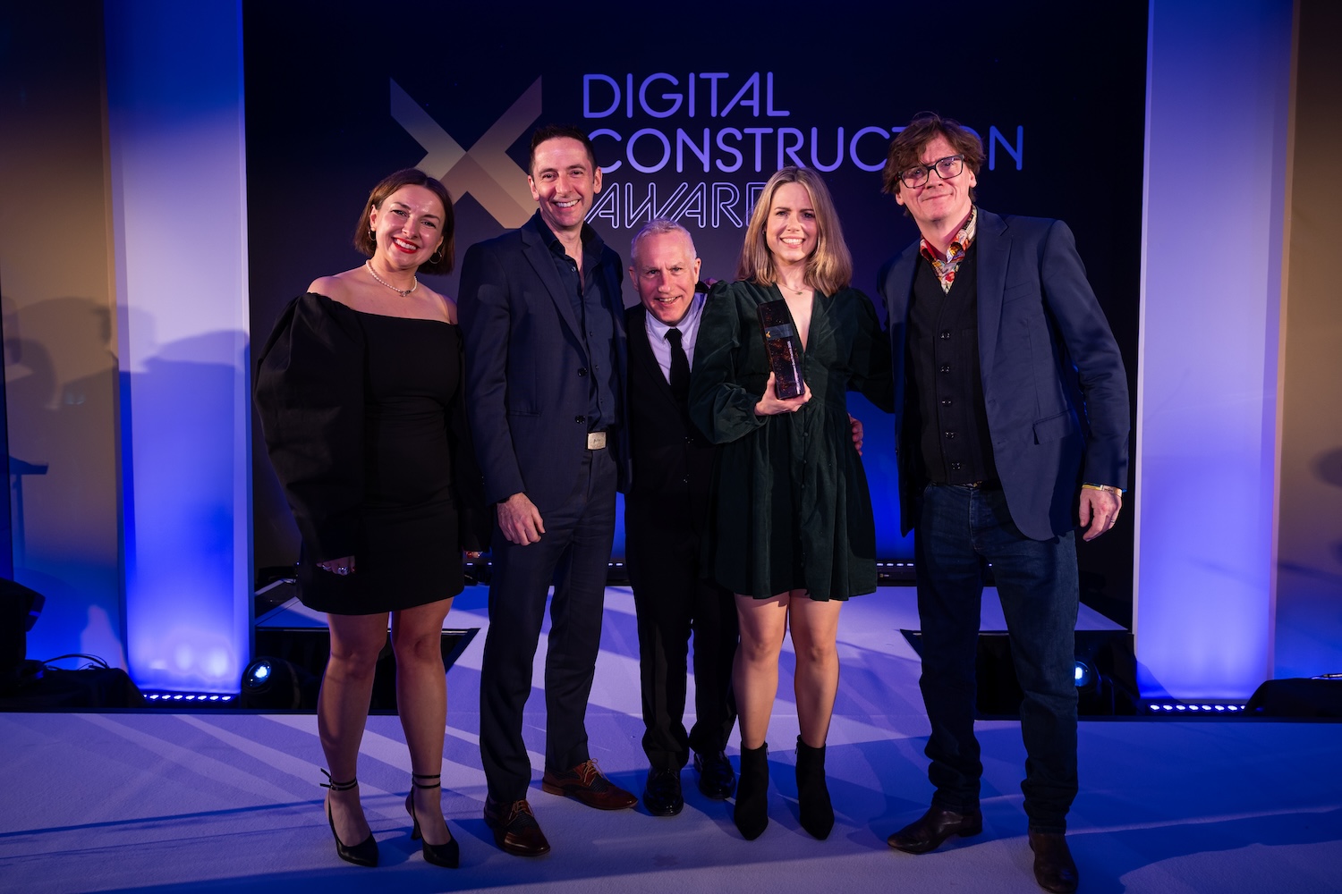 Jason Whittall (second left) and Vicki Reynolds (second right) of ONE Creative Environments collect their trophy from Ed Byrne (far right), Justin Kirby of Start with Smart (centre) and Karolina Orecchini from Digital Construction Week. Image: © 2026 - ASV Photography Ltd. www.ASVphotos.com