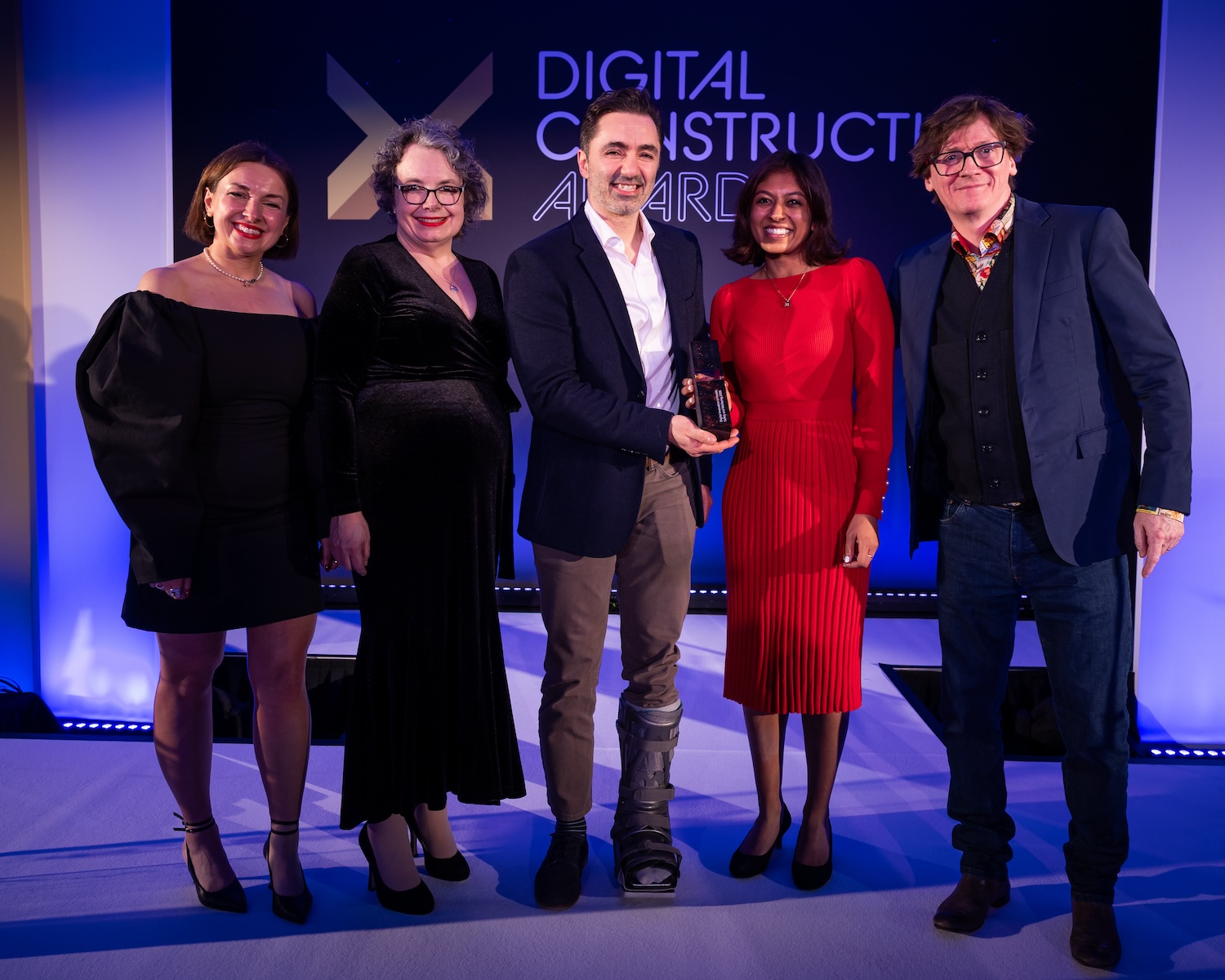 Quintessential Design collect the trophy from Ed Byrne (far right), awards judge Su Butcher (second left) and Karolina Orecchini from Digital Construction Week (far left). Image: © 2026 - ASV Photography Ltd. www.ASVphotos.com