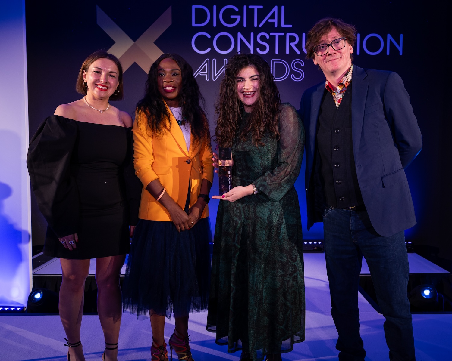 Emine Rachel Taylor-Unlu collects her trophy from Ed Byrne (far right), Ola Obadara from the CIOB (second left) and Karolina Orecchini of Digital Construction week (far left). Image: © 2026 - ASV Photography Ltd. www.ASVphotos.com