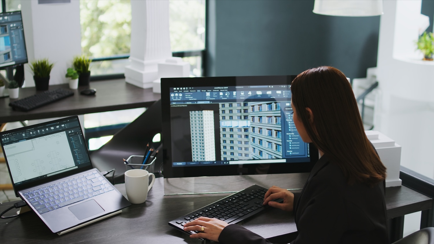 A woman reviewing a 3D model. Image: 313463026 | 3d Model Building © Dragoscondrea | Dreamstime.com