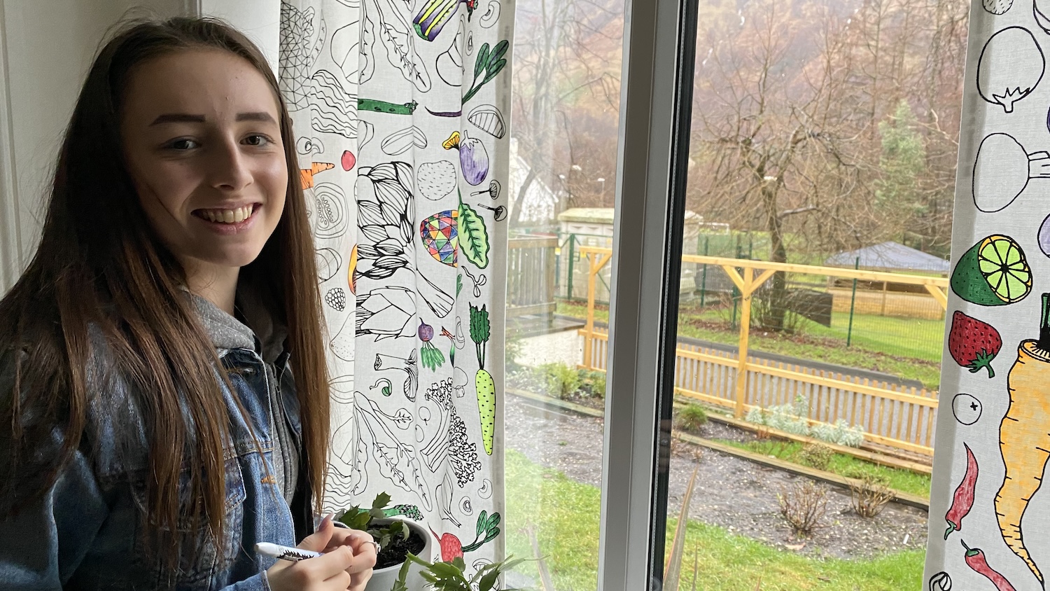 Sophie Philp colouring in Arto Kiviniemi's curtains